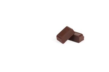Close-up pieces of chocolate bar with filling isolated on white background.