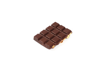 bar of dark chocolate with hazelnuts. Pieces of chocolate with nuts, isolated on white background.