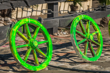 Fototapeta na wymiar Albania, Velipoja. Colourful wheels in front of the beach bar