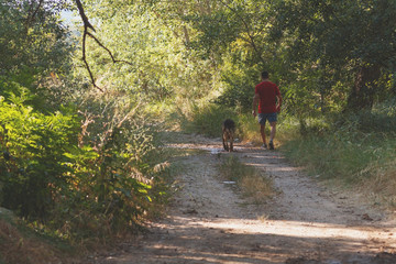 runner running across the field with his dog