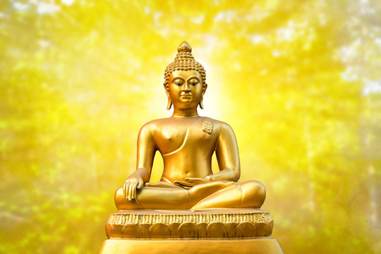 Beautiful of Golden Buddha statue on golden yellow bokeh background.