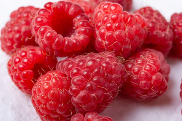 Fresh red raspberries on white background. Close Up.