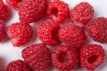 Fresh red raspberries on white background. Close Up.