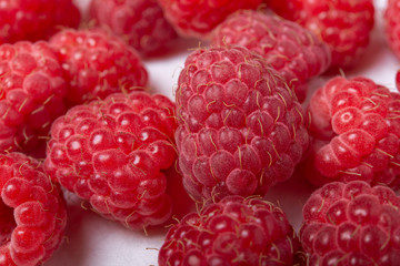 Fresh red raspberries on white background. Close Up.