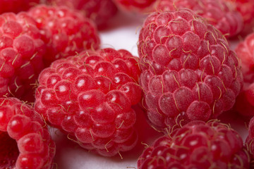 Fresh red raspberries on white background. Close Up.