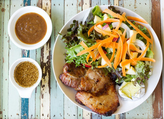 Homemade black pepper pork chop steak with salad. Top view.