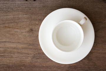 Empty clean cup on wood table. Top view with copy space.
