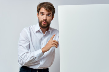 young man holding blank card