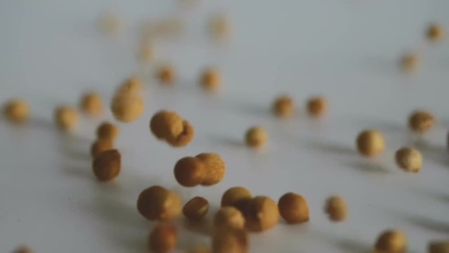 Close up coriander seed falling down on the floor , a slow motion shot