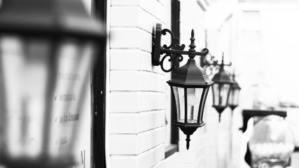 Vintage Old Street Classic Iron Lantern on the House Wall, Close Up in black and white