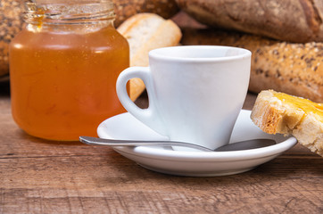 Breakfast with coffee and bread on wooden table. Selective focus