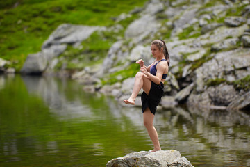 Fototapeta premium Woman kickbox fighter training by the lake