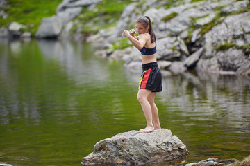Woman kickbox fighter training by the lake