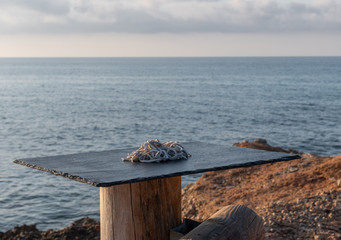 Photo landscape of a delicious typical Spanish dish - Cooked eels served on a stone table with the islands of the sea in the background