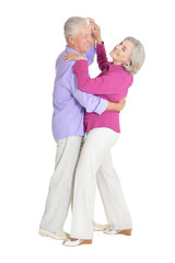portrait of happy senior couple dancing on white background