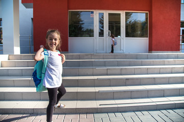 Back to school education concept with girl kids, elementary students, carrying backpacks going to class