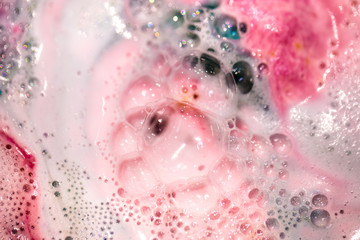 The bright bath bomb dissolves in water .
