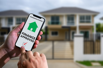 finance loan agreement and house key Mortgage Loan approval on mobile phone in a house