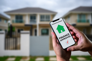 finance loan agreement and house key Mortgage Loan approval on mobile phone in a house