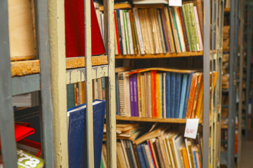 Blurred image of old books on bookshelves in the library