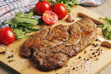 A beef steak well done with vegetables	