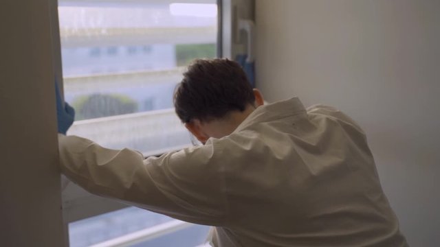 Disappointed Doctor Or Scientist Shaking His Head Next To Lab Or Hospital Window