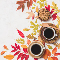 Coffee and cookies with autumn leaves copy space