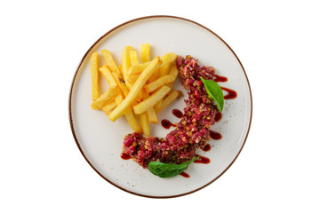 Beef tar tar  with balsamic sauce, basil and french fries isolated on white