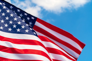 American flag waving in the wind against blue sky