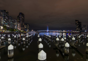 Beautiful night view of Melbourne docklands and Bolte Bridge, with reflections on the Yarra River,...