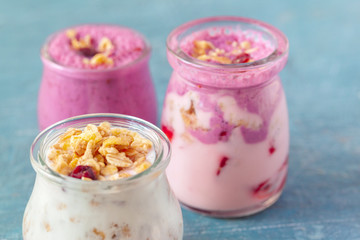 healthy products for breakfast, granola and fresh berries on white table