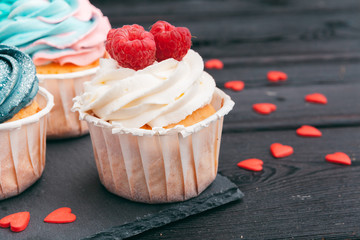 Set of different delicious cupcakes on dark