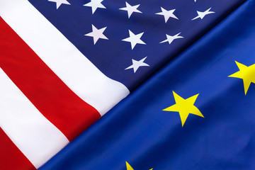 Closeup of Flags of USA and European Union lying together on table