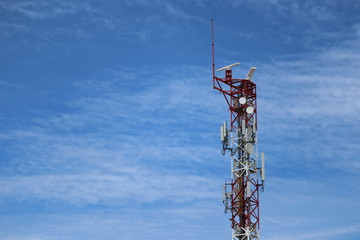 cell phone antenna tower on blue sky 