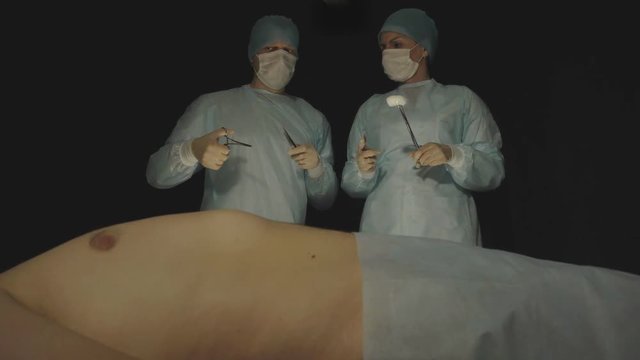 Two surgeons, a man and a girl, discuss and consult about the upcoming surgery, medicine