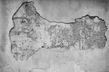 Monochrome old wall with a hole from the fallen off plaster