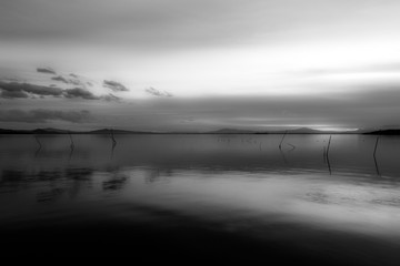 Beautiful and symmetric sunset over Trasimeno lake (Umbria, Italy)