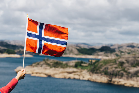 Tourist With Norwegian Flag On Sea Coast