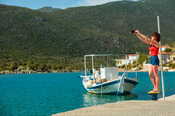 Tourist take photo in greek marina