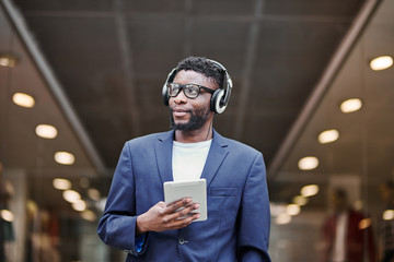 Man in headphones walking down the street.