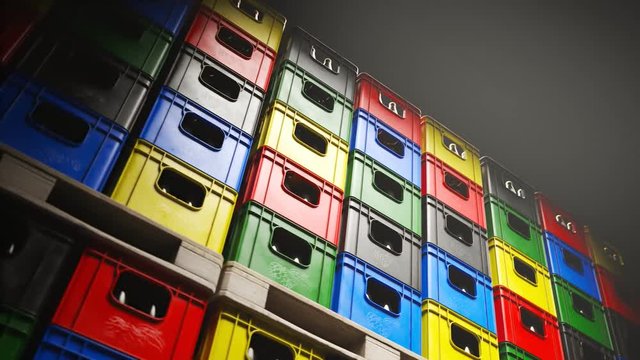 Loop of countless colorful beer crates stacked in a warehouse during night 4KHD