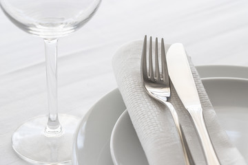 Table set with silver cutlery and glassware. Dinning concept background. Close up.