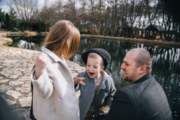 Fototapeta premium Father with daughter and son having fun spending time together outdoors.