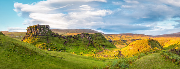 Panorama of famous mystic Fairy Glen at sunset, a green valley with romantic landscapes. Copy space in sky. - obrazy, fototapety, plakaty