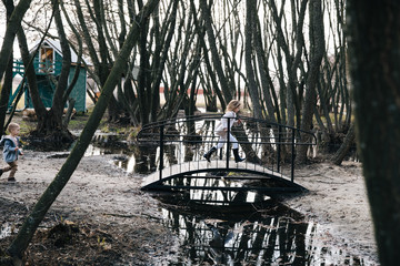 Children have fun and running across the bridge . Children play near the water. happy kids running...