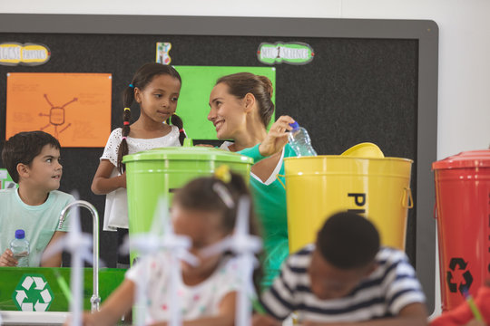 Teacher Discussing With School Kids About Green Energy In Classroom