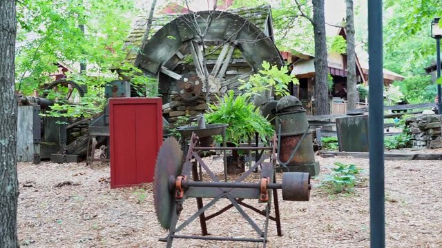 Old water wheel being driven by a small stream of water in the Ozark Mountains