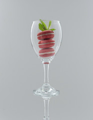 Traditional French colorful macaroons in a wine glass.