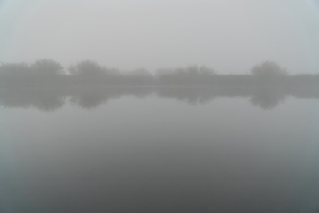 Mystical Fog in the early morning on a small lake