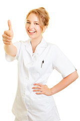 Woman as a dentist holds thumbs up